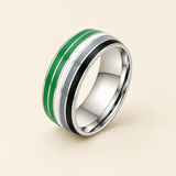 Green, white, grey and black striped ring on an ivory background
