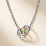 Rainbow interlocking ring necklace on an ivory background