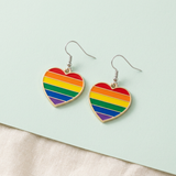Rainbow heart earrings styled flat lay